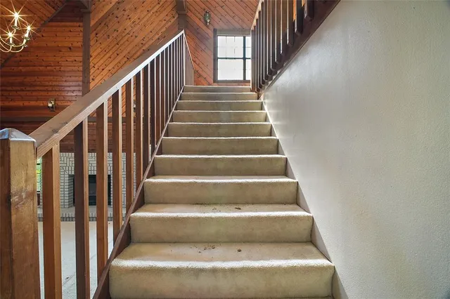 a view of a porch with wooden floor and fence