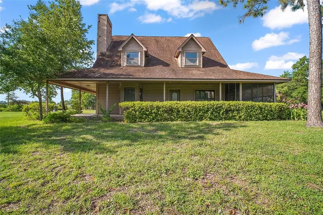 a front view of house with yard and green space