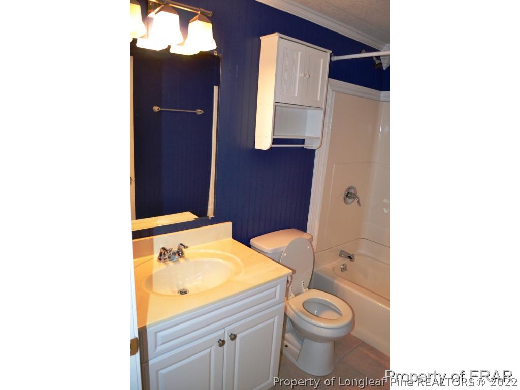 105 Beard Road Raeford, NC 28376 - Photo 11 of 29 a bathroom with a granite countertop toilet and a sink