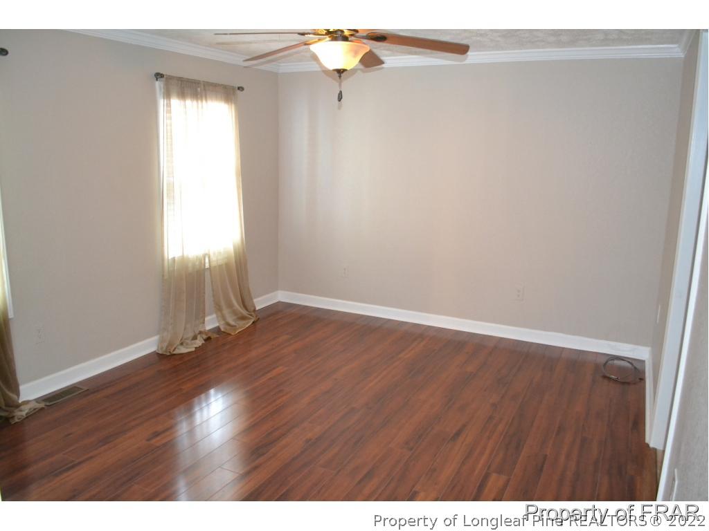 105 Beard Road Raeford, NC 28376 - Photo 15 of 29 a view of an empty room with wooden floor and a window