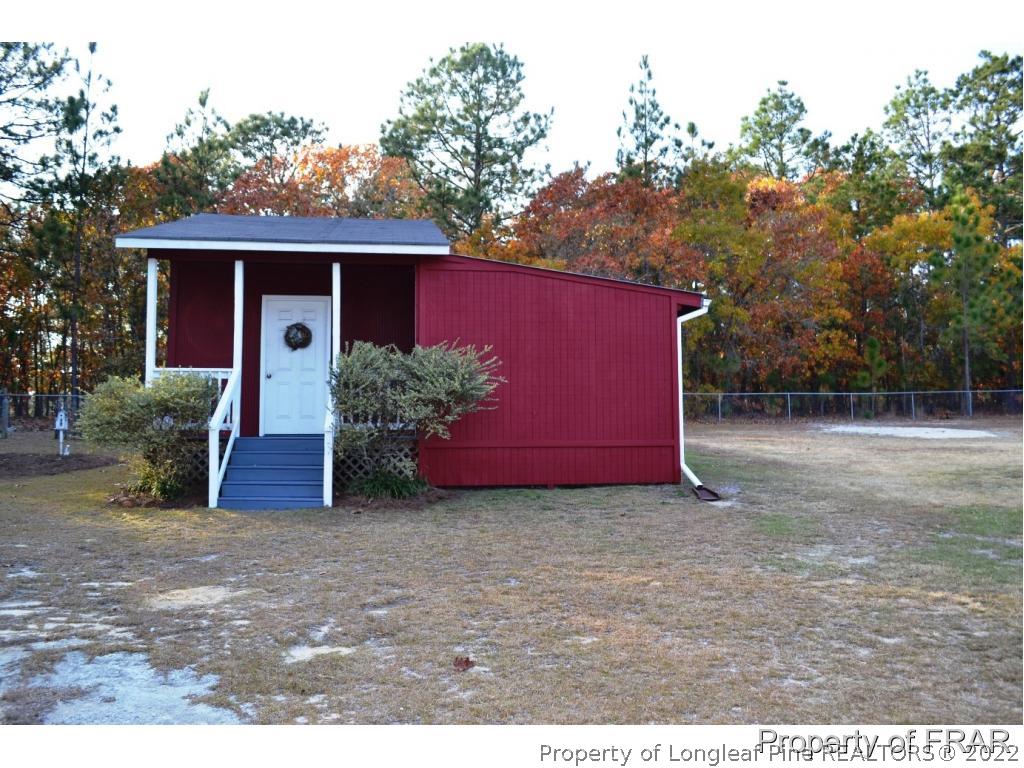 105 Beard Road Raeford, NC 28376 - Photo 27 of 29 a view of a backyard with potted plants and large tree