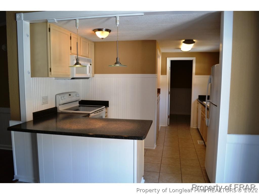 105 Beard Road Raeford, NC 28376 - Photo 3 of 29 a kitchen with stainless steel appliances granite countertop a sink dishwasher and a refrigerator