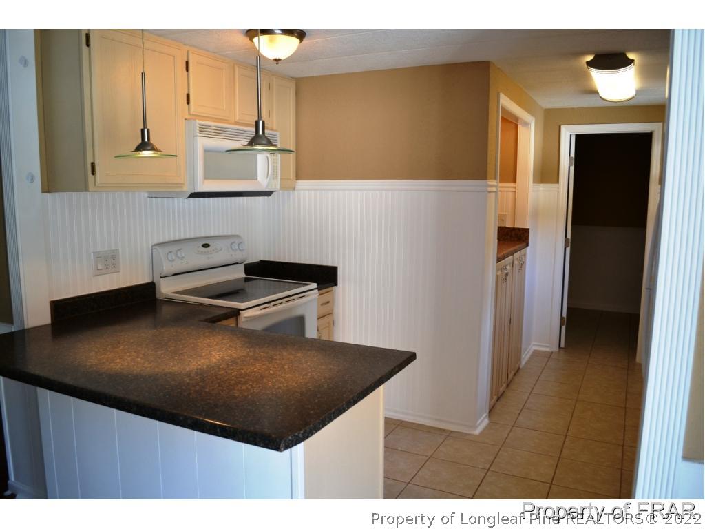105 Beard Road Raeford, NC 28376 - Photo 5 of 29 a kitchen with a sink and cabinets