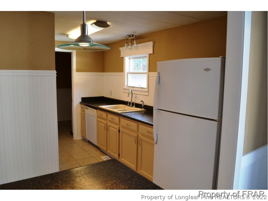 105 Beard Road Raeford, NC 28376 - Photo 6 of 29 a kitchen with a refrigerator and a sink