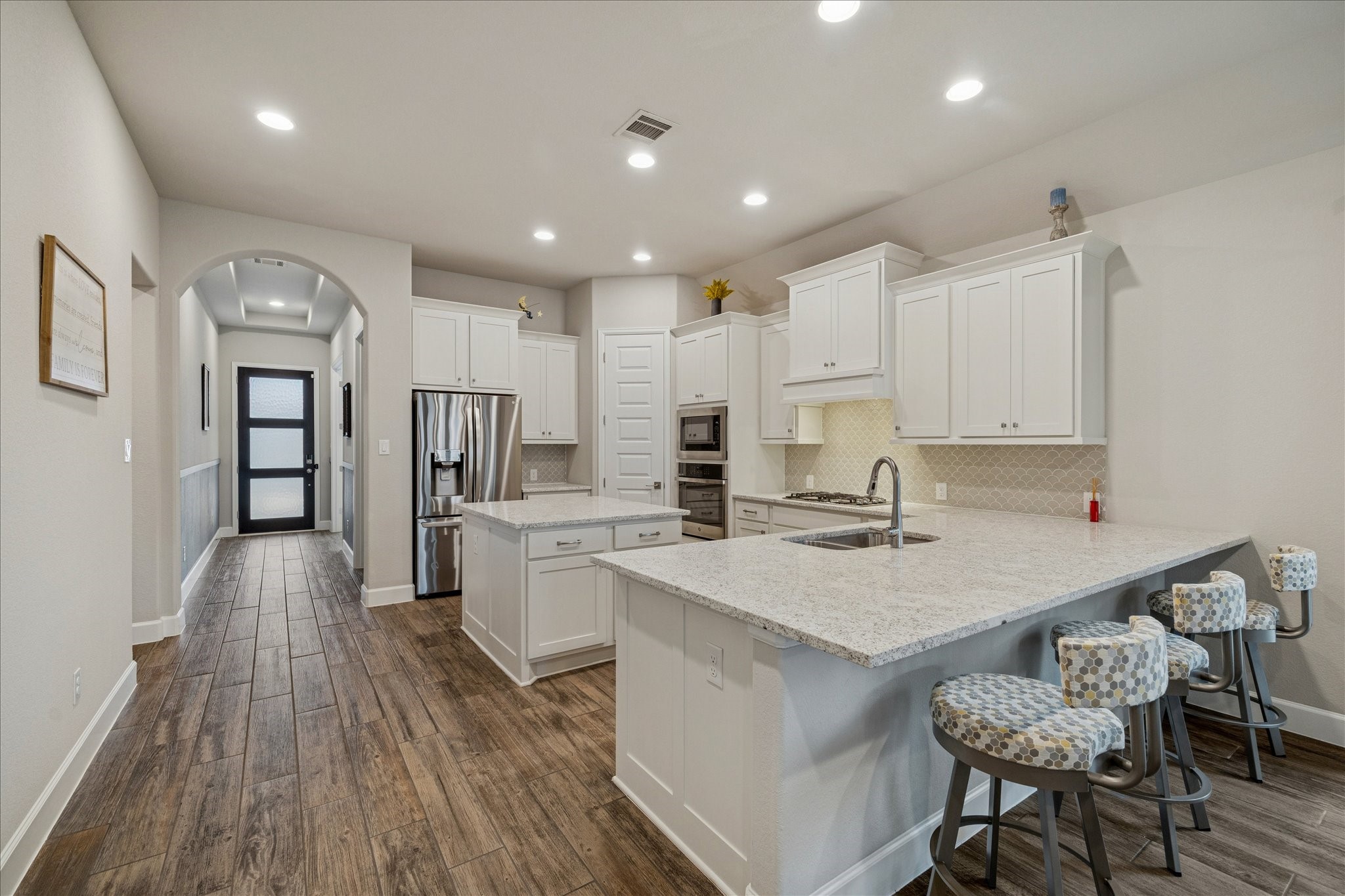 7354 Mount Greylock Loop Porter, TX 77365 - Photo 10 of 18 a kitchen with a sink a center island stainless steel appliances and cabinets