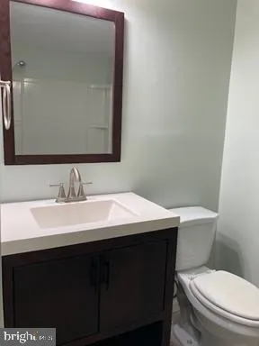 a bathroom with a sink a toilet and mirror