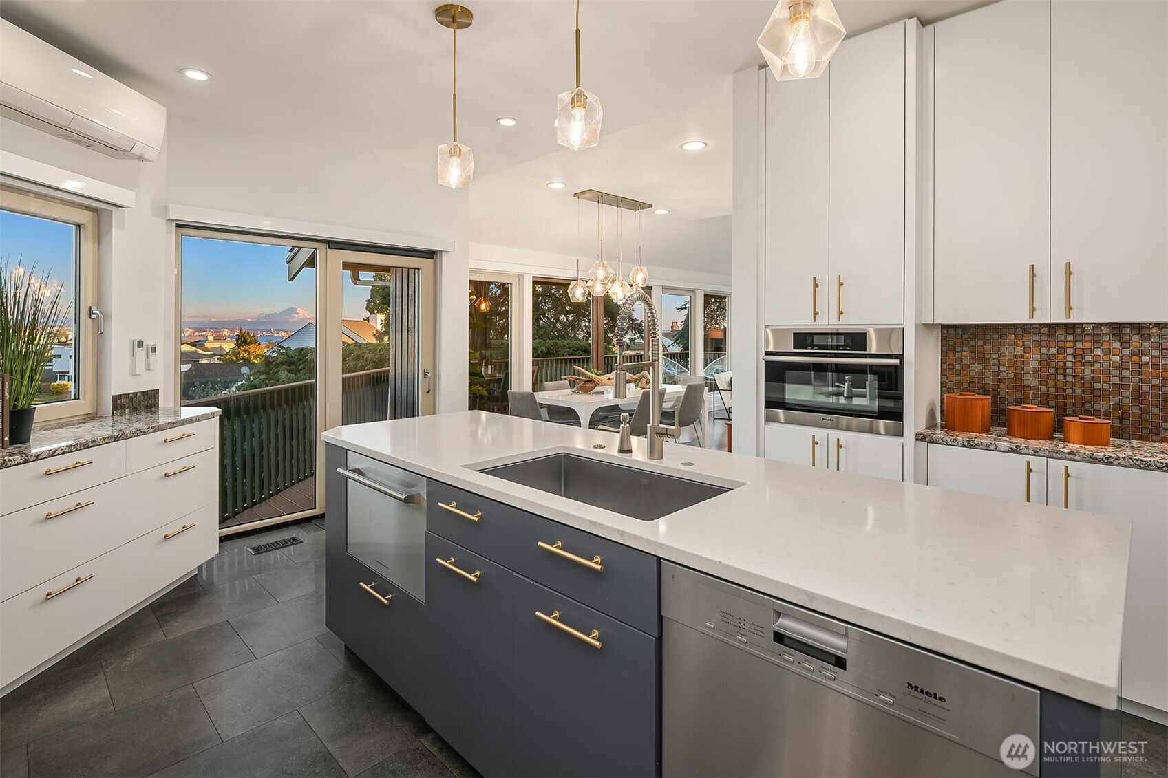 2016 Constance Drive West Seattle, WA 98199 - Photo 11 of 40 a kitchen with stainless steel appliances kitchen island granite countertop a sink a stove and a refrigerator