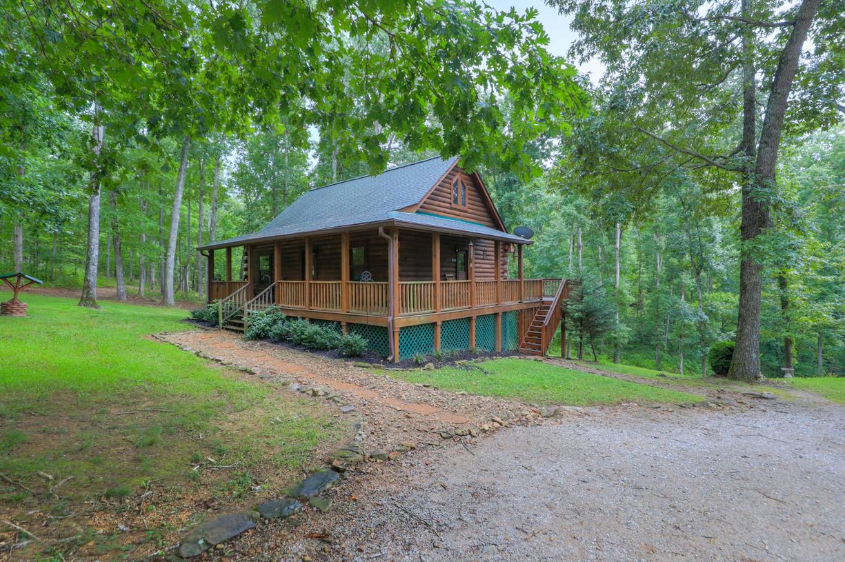 6407 Tom Rail Road Primm Springs, TN 38476 - Photo 2 of 23 a house with trees in the background
