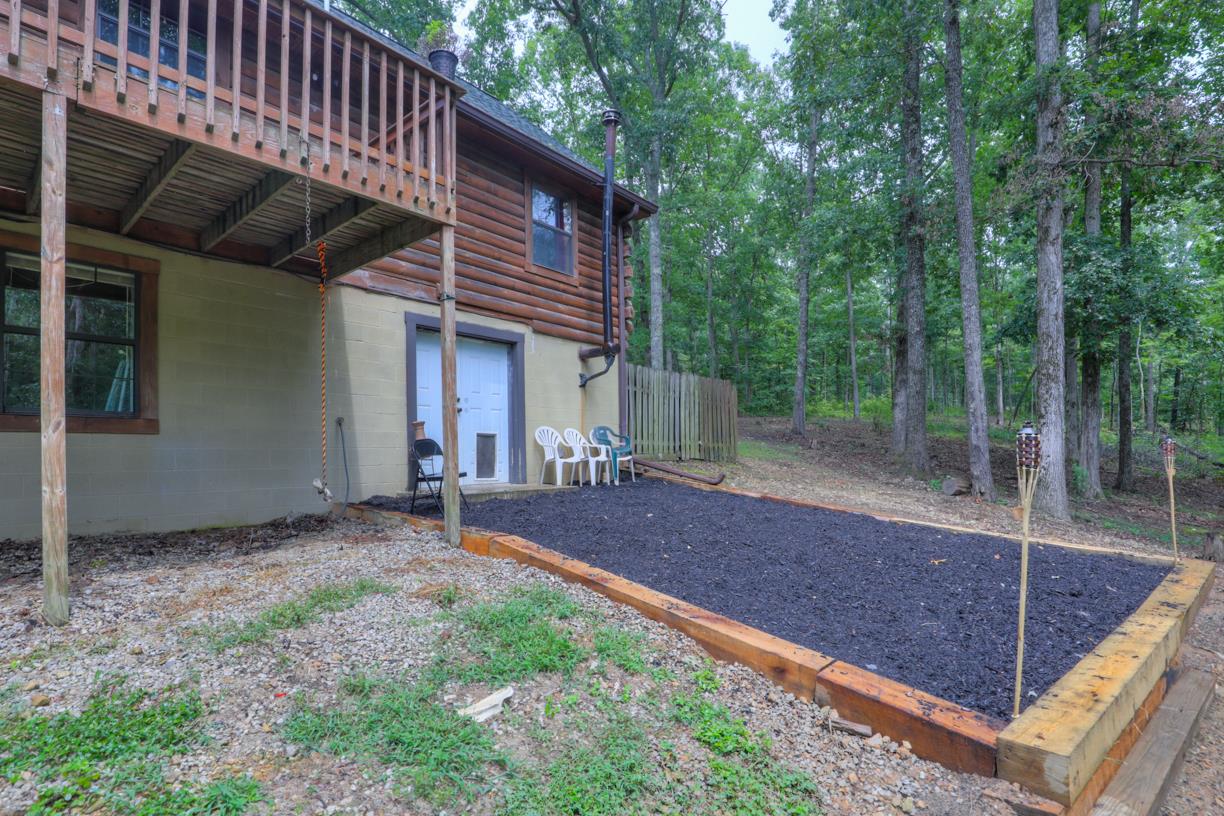 6407 Tom Rail Road Primm Springs, TN 38476 - Photo 20 of 23 a view of a house with backyard and garden