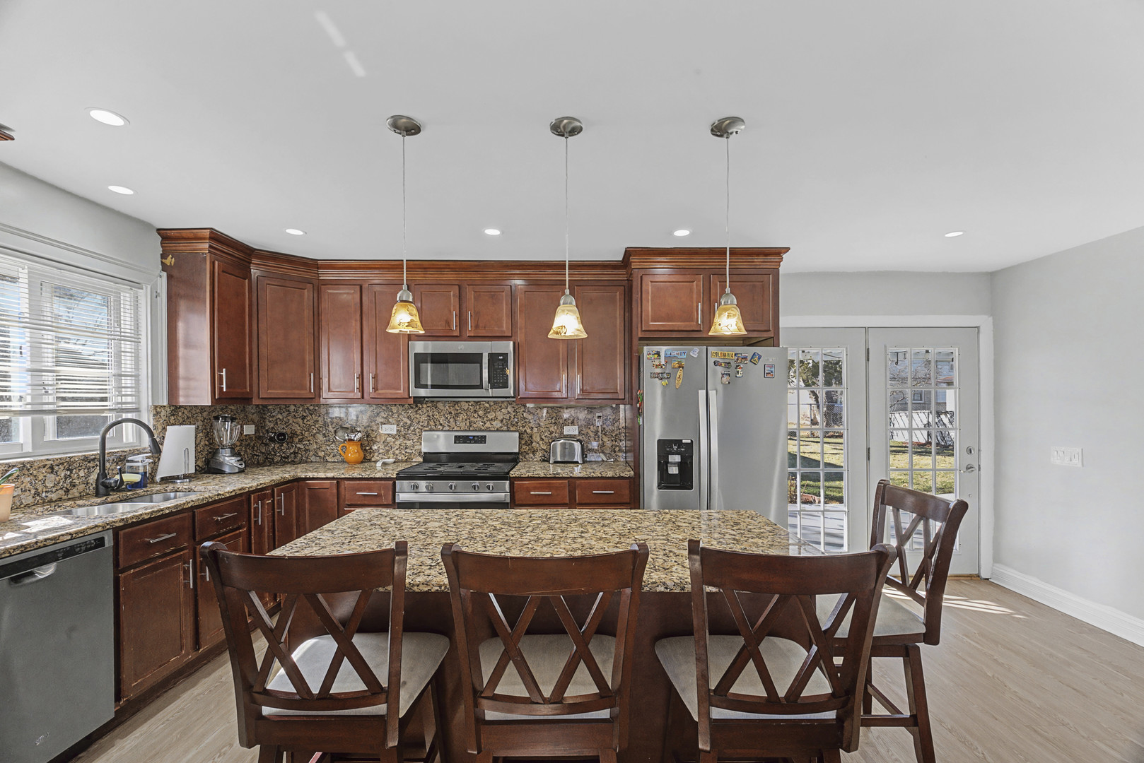 102 South Adeline Avenue Addison, IL 60101 - Photo 3 of 20 a kitchen with a dining table chairs and refrigerator