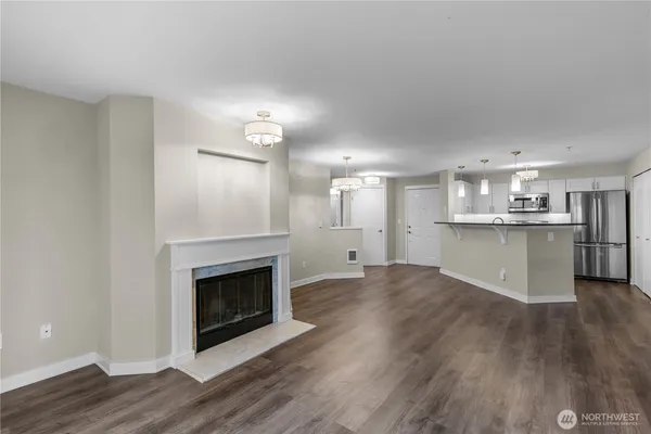 a view of kitchen and fireplace with wooden floor
