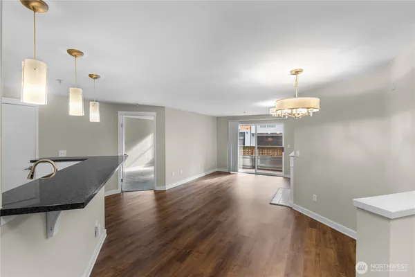 a view of a livingroom with furniture wooden floor and chandelier