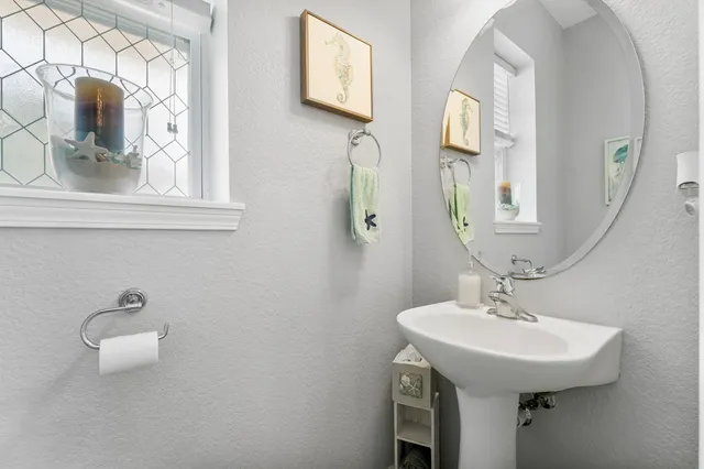 a kitchen with a refrigerator a sink dishwasher and white cabinets with wooden floor