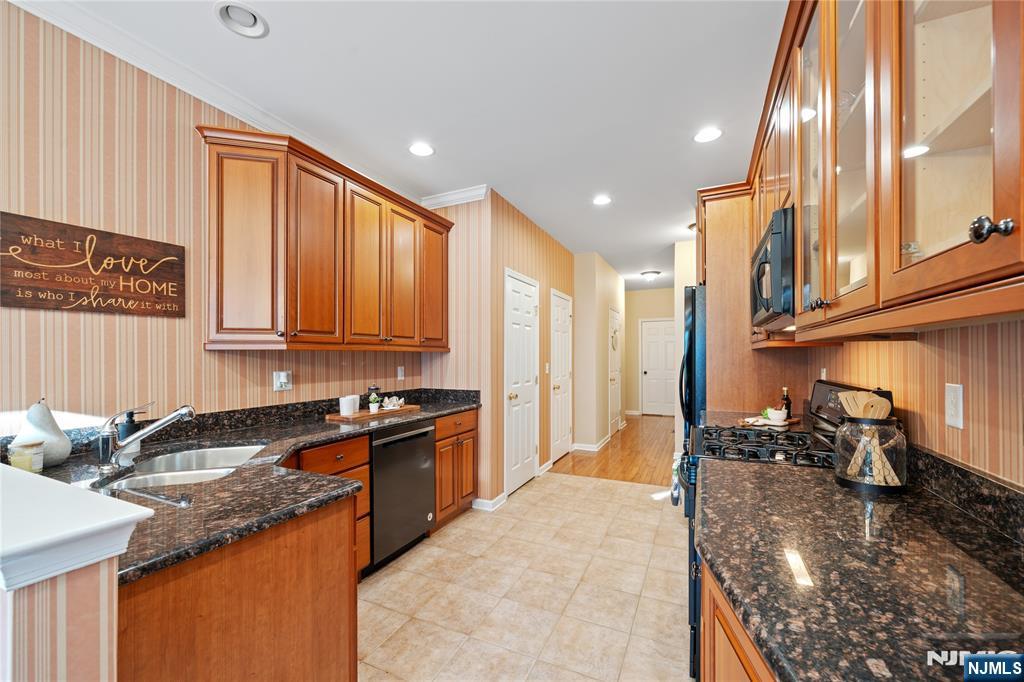 26 Chestnut Court Cedar Grove, NJ 07009 - Photo 11 of 42 a kitchen with stainless steel appliances granite countertop a sink stove and cabinets