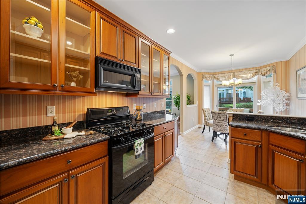 26 Chestnut Court Cedar Grove, NJ 07009 - Photo 13 of 42 a kitchen with stainless steel appliances granite countertop a stove a sink and a microwave