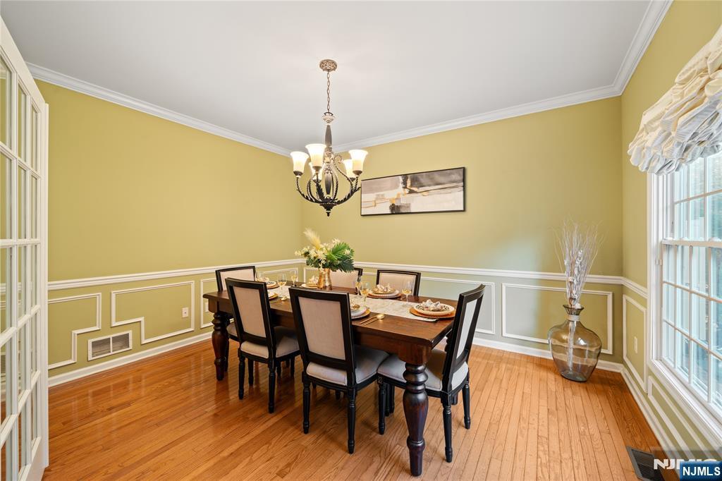 26 Chestnut Court Cedar Grove, NJ 07009 - Photo 14 of 42 a view of a dining room with furniture wooden floor and chandelier