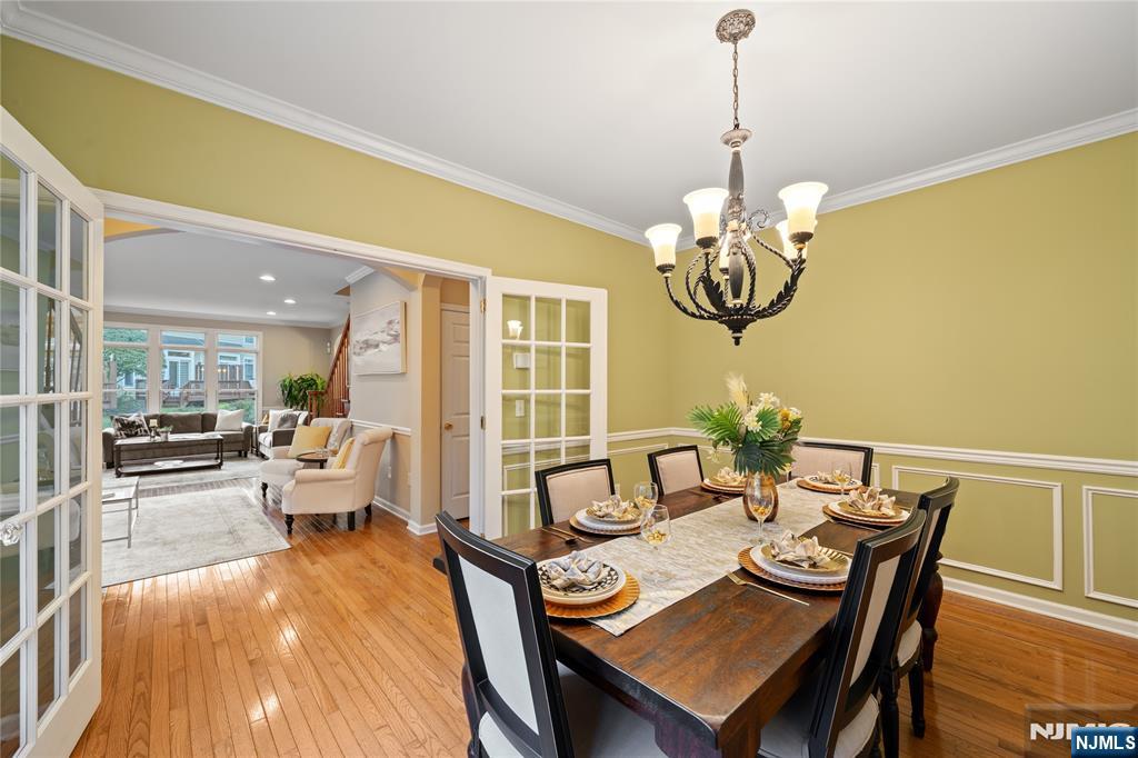 26 Chestnut Court Cedar Grove, NJ 07009 - Photo 15 of 42 a view of a dining room with furniture wooden floor and chandelier