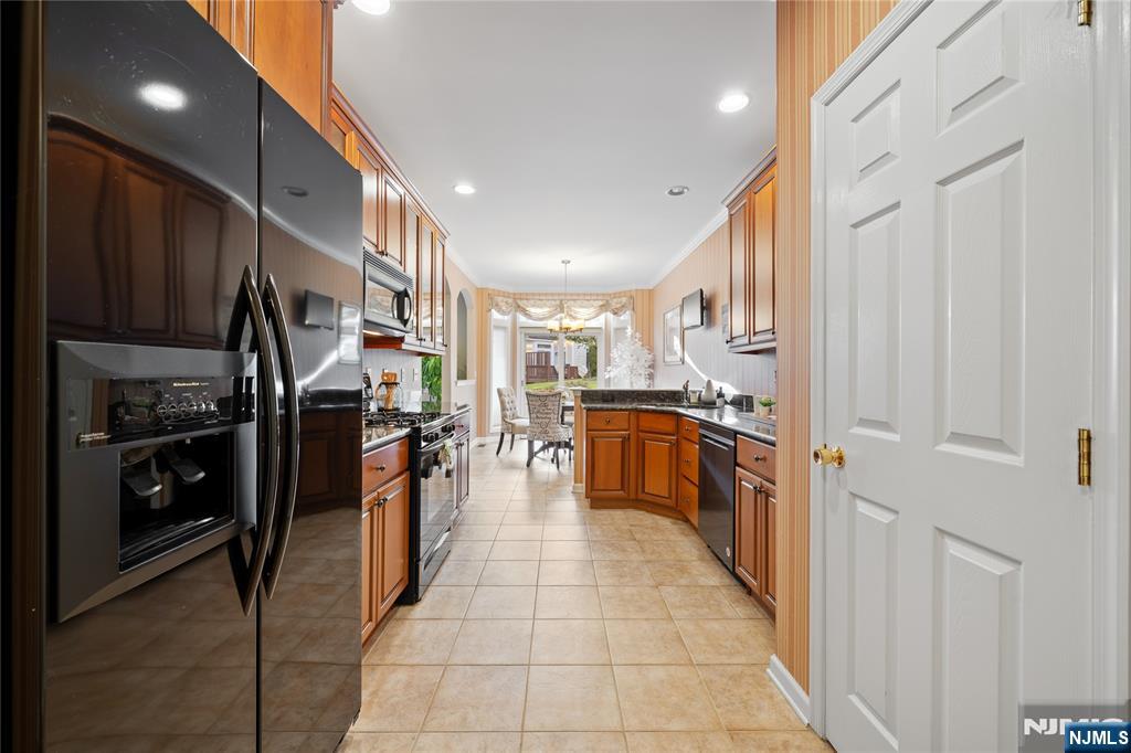 26 Chestnut Court Cedar Grove, NJ 07009 - Photo 17 of 42 a kitchen with stainless steel appliances a refrigerator and a sink