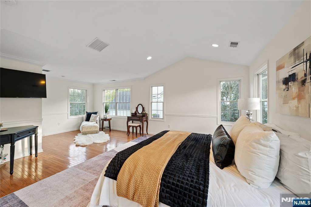 26 Chestnut Court Cedar Grove, NJ 07009 - Photo 21 of 42 a spacious bedroom with a bed and a flat screen tv