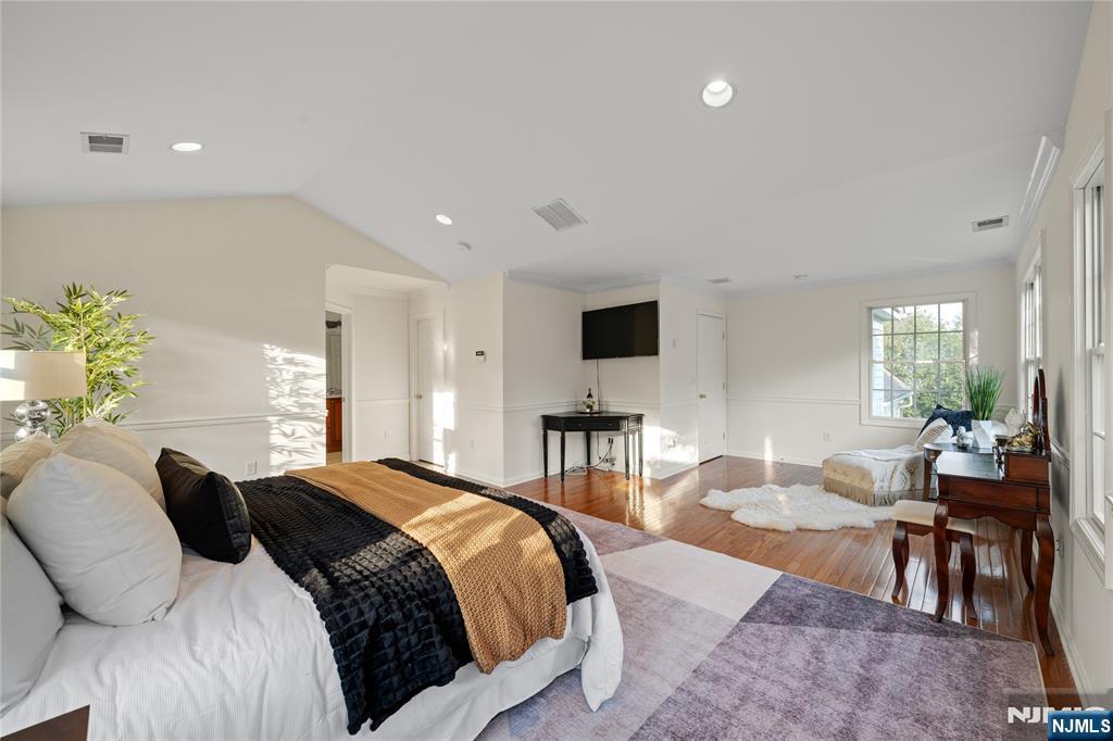 26 Chestnut Court Cedar Grove, NJ 07009 - Photo 22 of 42 a spacious bedroom with a bed a table and chair