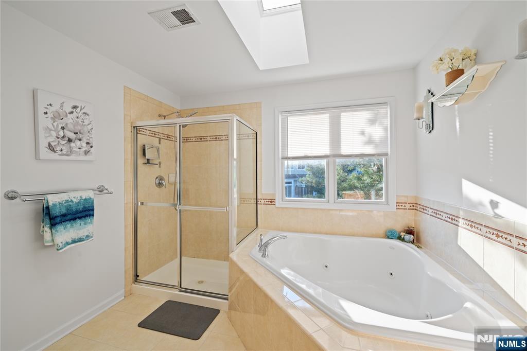 26 Chestnut Court Cedar Grove, NJ 07009 - Photo 27 of 42 a bathroom with a bathtub and a shower