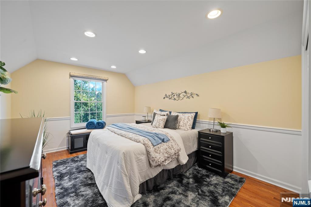 26 Chestnut Court Cedar Grove, NJ 07009 - Photo 29 of 42 a bed room with a bed and a chair