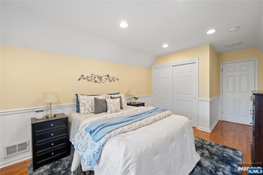 26 Chestnut Court Cedar Grove, NJ 07009 - Photo 30 of 42 a bedroom with a bed and wooden floor