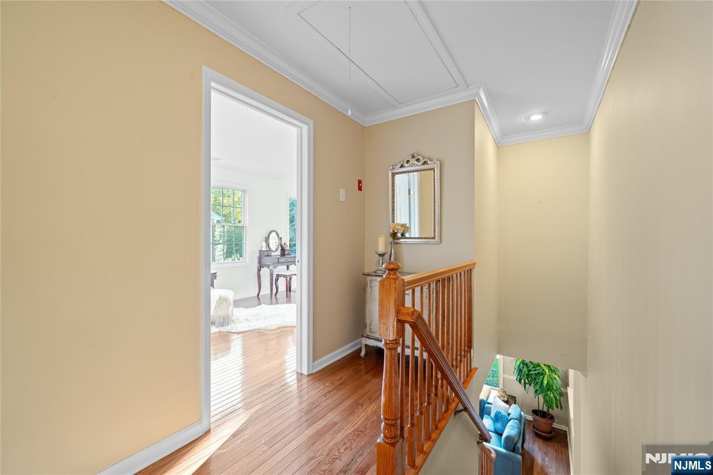 26 Chestnut Court Cedar Grove, NJ 07009 - Photo 33 of 42 a view of a hallway with wooden floor and a dining room