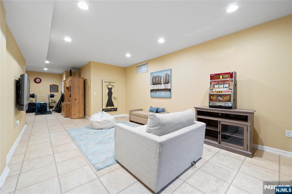 26 Chestnut Court Cedar Grove, NJ 07009 - Photo 35 of 42 a living room with furniture and a flat screen tv