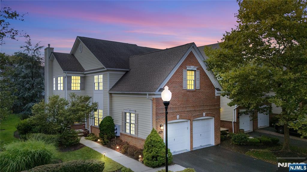 26 Chestnut Court Cedar Grove, NJ 07009 - Photo 42 of 42 a front view of a house with a yard and garage