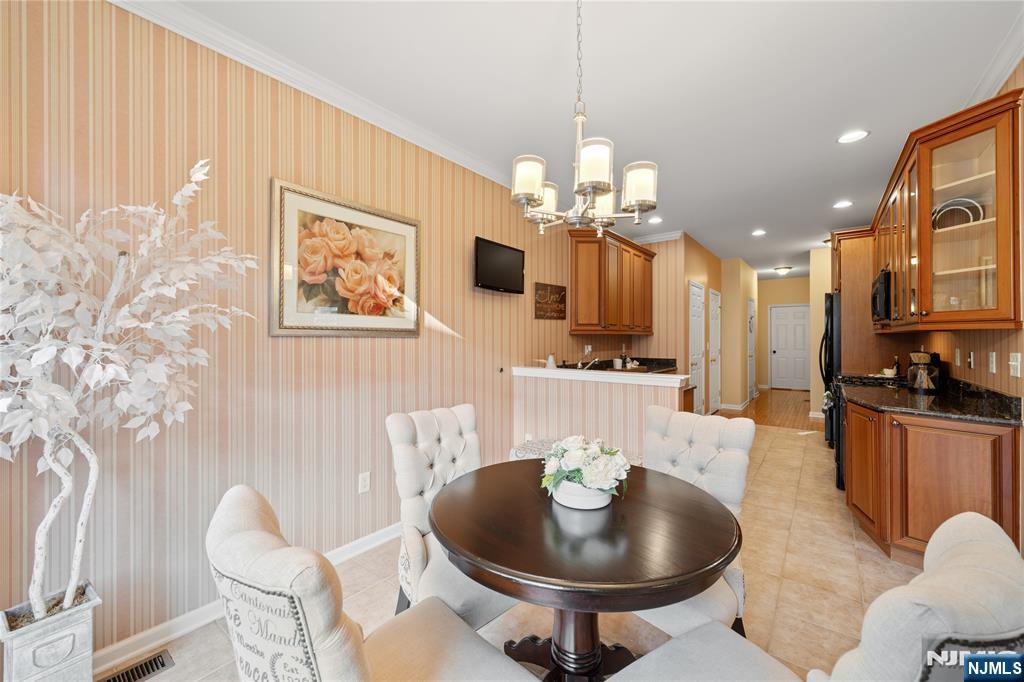 26 Chestnut Court Cedar Grove, NJ 07009 - Photo 9 of 42 a living room with furniture kitchen and a chandelier
