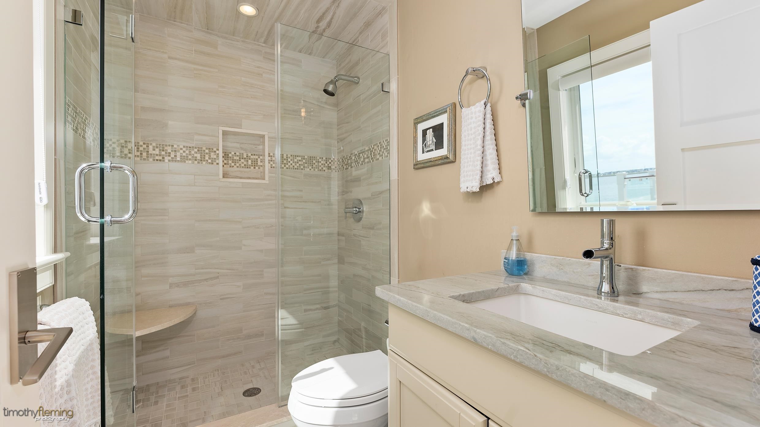 7668 Sunset Drive Avalon, NJ 08202 - Photo 37 of 49 a bathroom with a granite countertop sink a toilet and shower