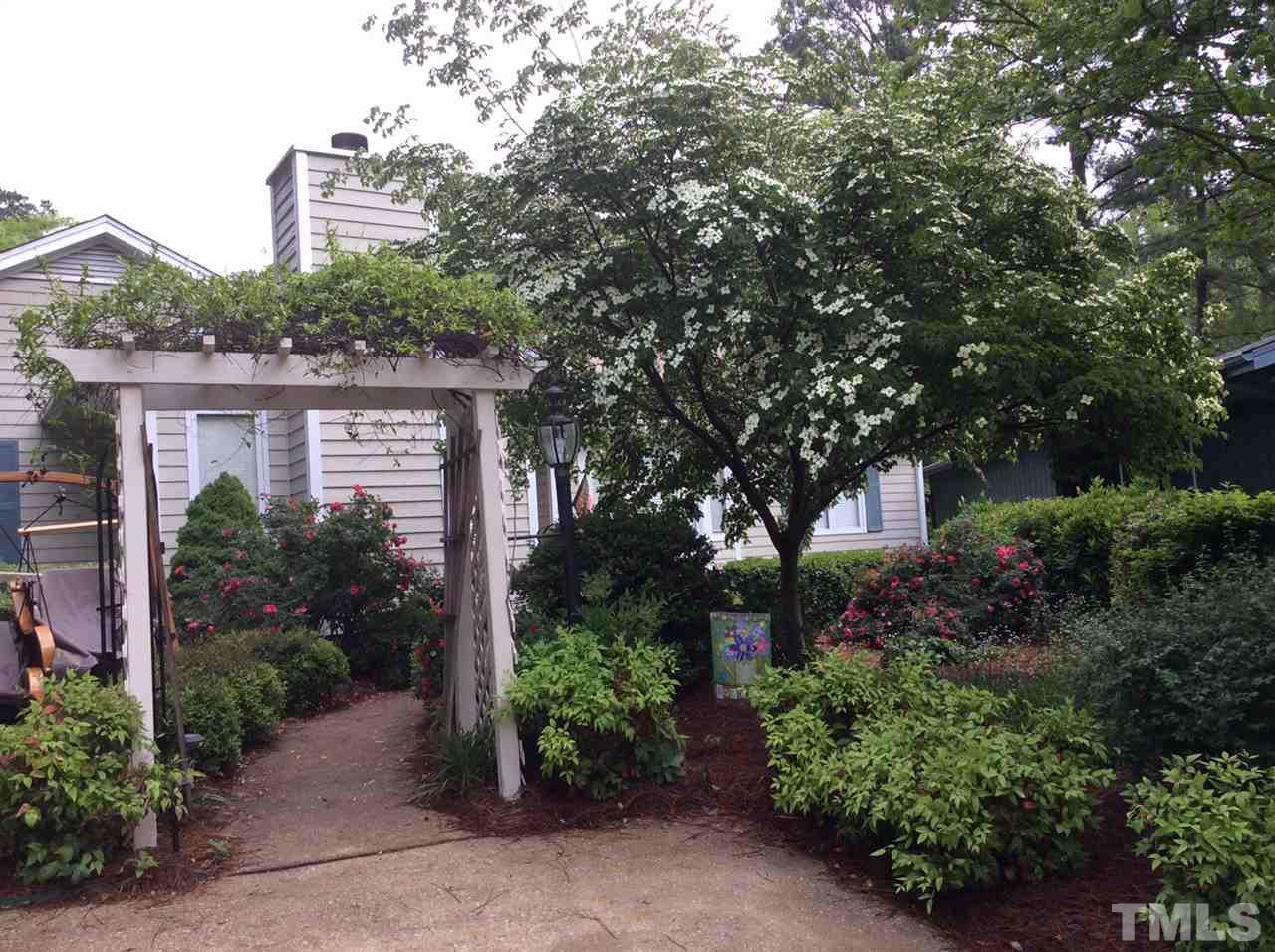 2758 Rue Sans Famille Raleigh, NC 27607 - Photo 2 of 12 front view of a house with a garden