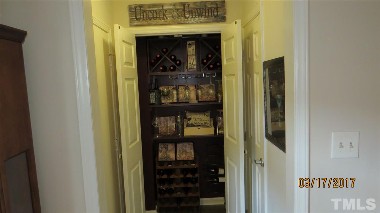 2758 Rue Sans Famille Raleigh, NC 27607 - Photo 11 of 12 a view of a hallway with wooden shelves