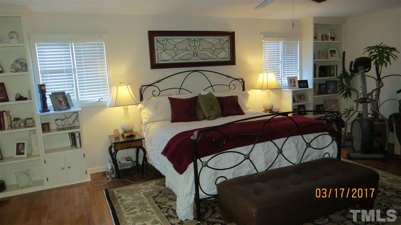 2758 Rue Sans Famille Raleigh, NC 27607 - Photo 5 of 12 a bedroom with a bed and wooden floor