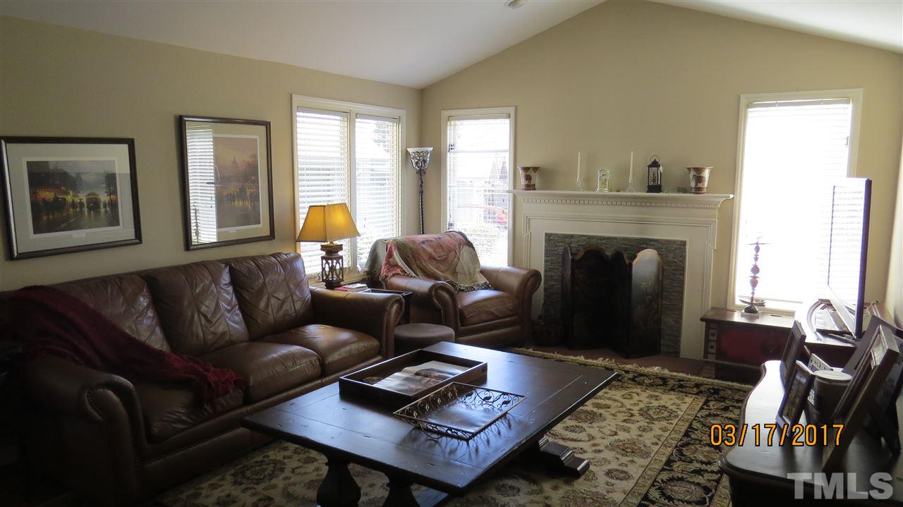 2758 Rue Sans Famille Raleigh, NC 27607 - Photo 7 of 12 a living room with furniture and a fireplace