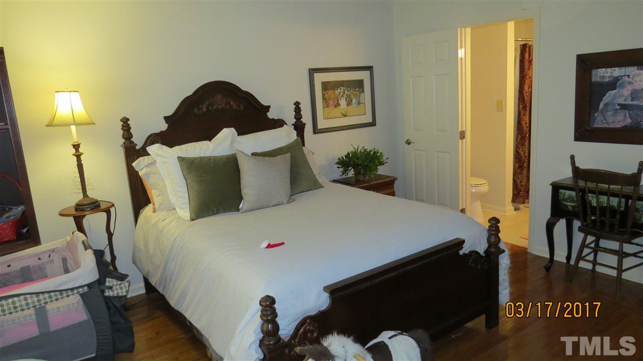2758 Rue Sans Famille Raleigh, NC 27607 - Photo 10 of 12 a bed sitting in a bedroom next to a window
