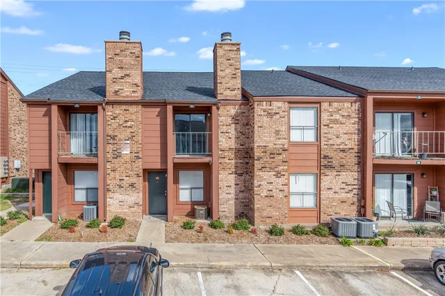 a front view of a building with a garden