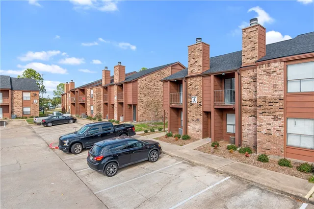 a car parked in front of a brick house
