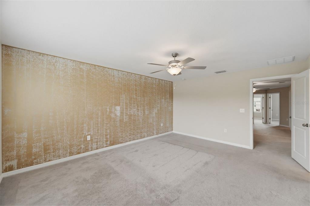 8606 Reedville Street New Port Richey, FL 34654 - Photo 28 of 100 a view of an empty room with a chandelier fan