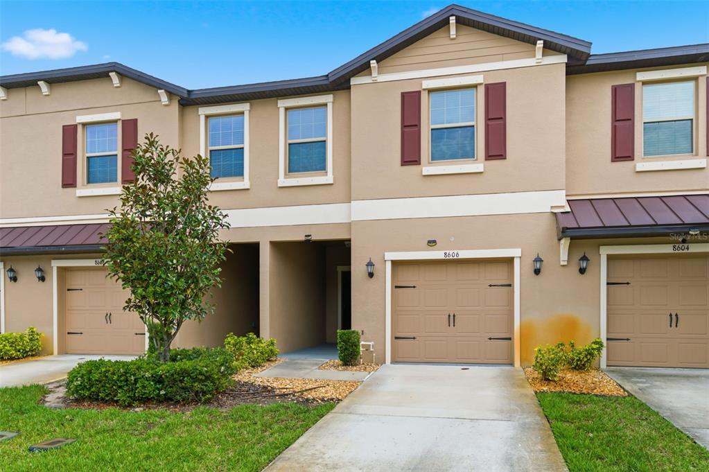 8606 Reedville Street New Port Richey, FL 34654 - Photo 3 of 100 a front view of a house with a yard and garage