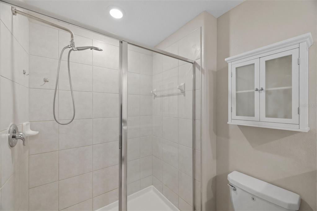 8606 Reedville Street New Port Richey, FL 34654 - Photo 32 of 100 a bathroom with a shower and a toilet