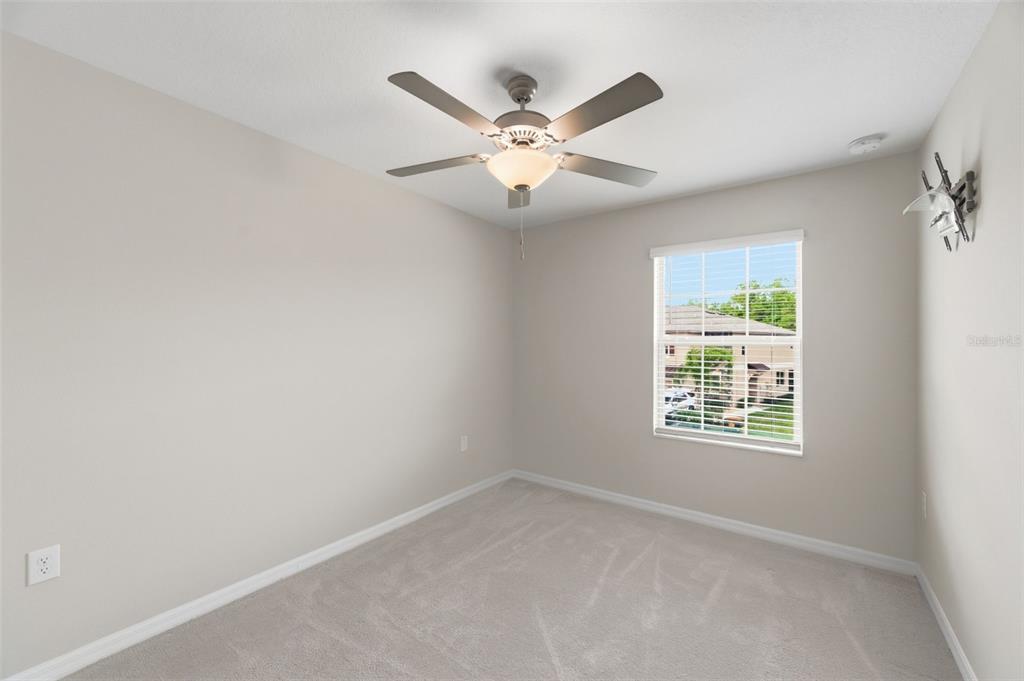 8606 Reedville Street New Port Richey, FL 34654 - Photo 34 of 100 an empty room with window and ceiling fan