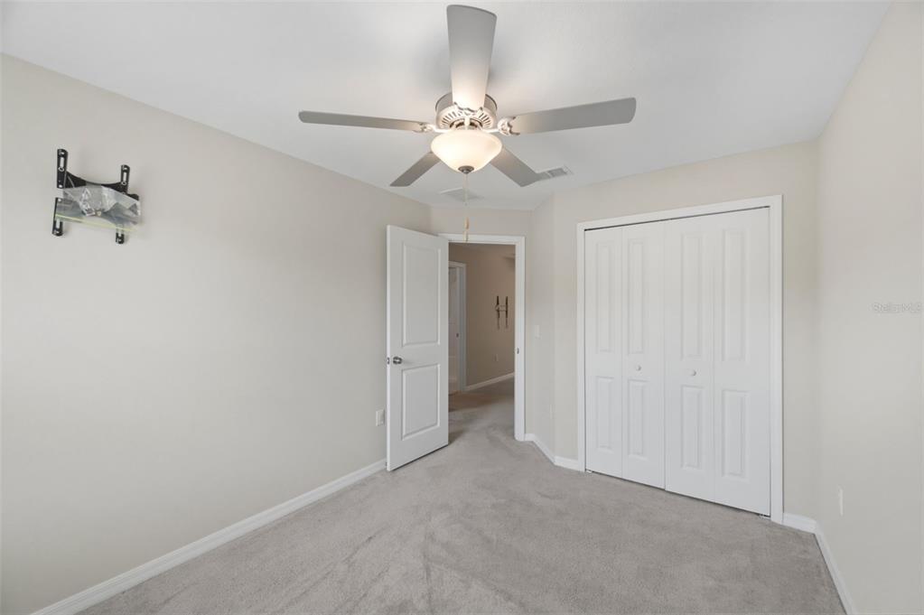 8606 Reedville Street New Port Richey, FL 34654 - Photo 36 of 100 a view of an empty room and chandelier fan
