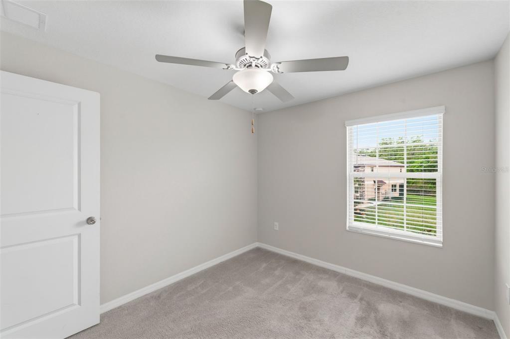 8606 Reedville Street New Port Richey, FL 34654 - Photo 39 of 100 an empty room with a window and a fan