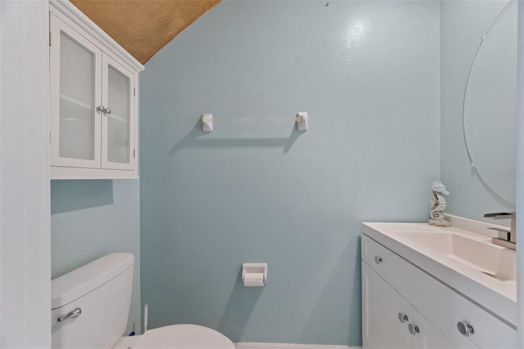 8606 Reedville Street New Port Richey, FL 34654 - Photo 44 of 100 a bathroom with a sink a toilet and a mirror