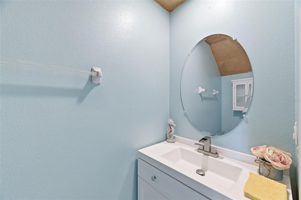 8606 Reedville Street New Port Richey, FL 34654 - Photo 45 of 100 a bathroom with a sink vanity and mirror