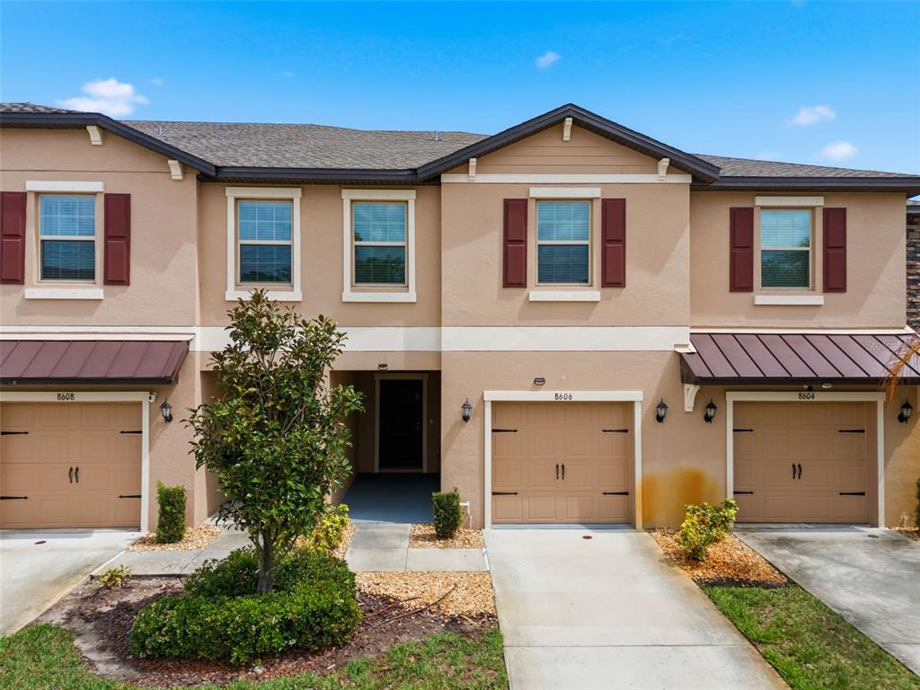 8606 Reedville Street New Port Richey, FL 34654 - Photo 57 of 100 a front view of a house with a yard and garage