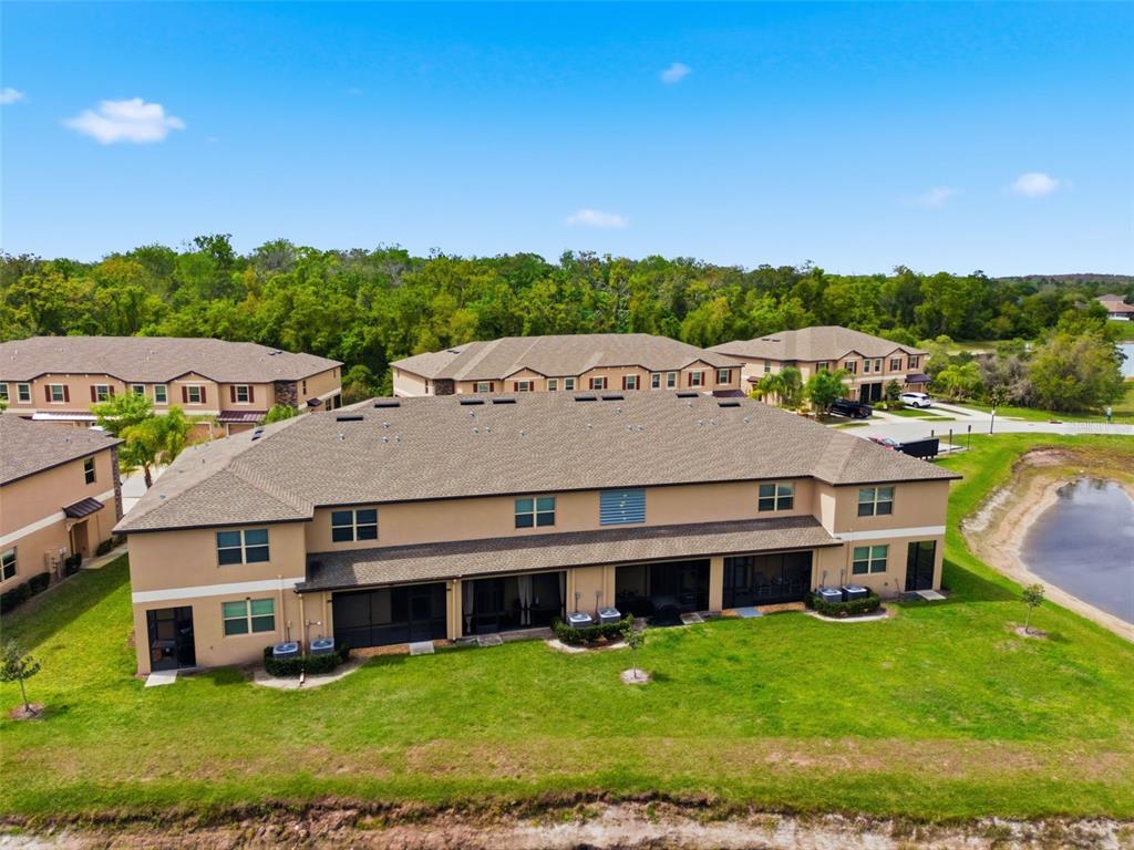 8606 Reedville Street New Port Richey, FL 34654 - Photo 66 of 100 an aerial view of residential houses with yard and lake view