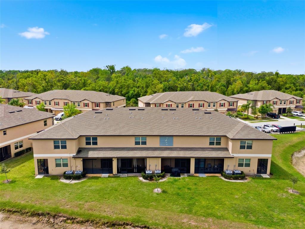 8606 Reedville Street New Port Richey, FL 34654 - Photo 67 of 100 a view of a big house with a big yard and large trees